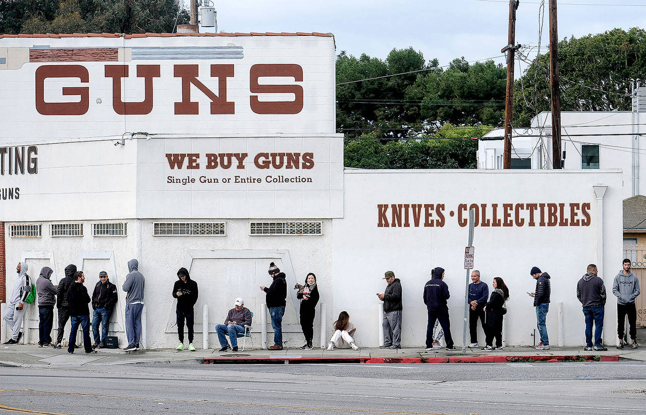 People wait in a line to enter a gun store in Culver City, California on March 15. (AP Photo/Ringo H.W. Chiu)