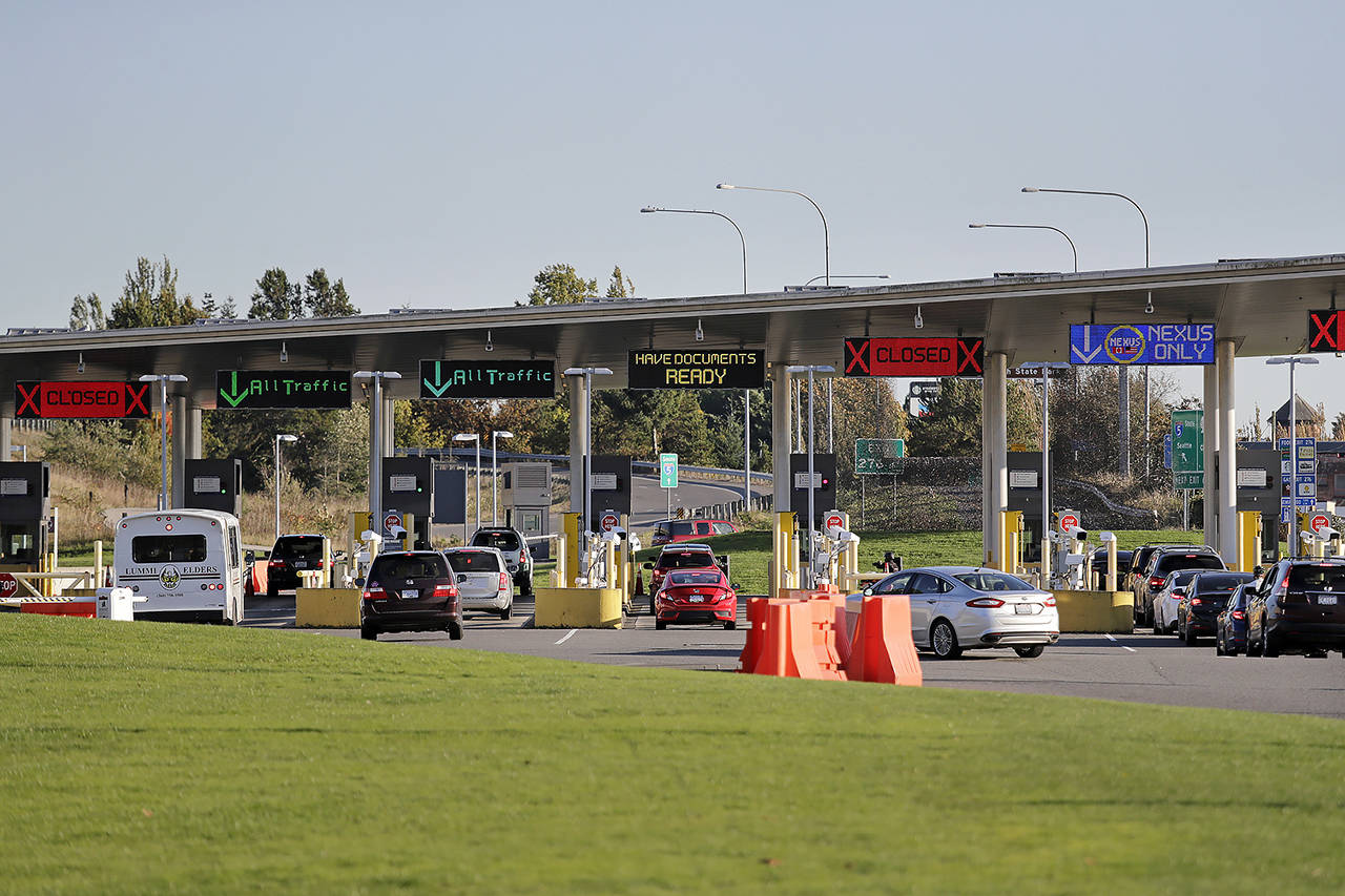 Traffic enters the United States from Canada at the Peace Arch Border Crossing in Blaine. (AP Photo/Elaine Thompson)