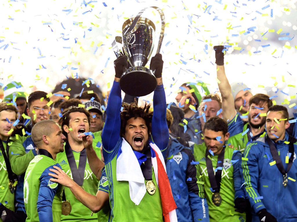 The Sounders’ Roman Torres (center) hoists the trophy after winning the MLS Cup final over Toronto FC in 2016 in Toronto. (Frank Gunn/The Canadian Press via AP)
