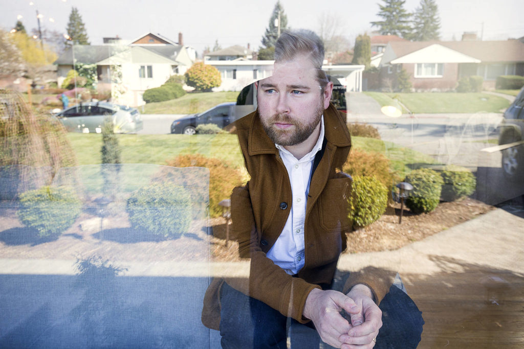 Tyler Chism, seen here Friday, was diagnosed with COVID-19 earlier in March and is currently cleared, by CDC standards. But the 33-year-old City of Everett employee and musician chooses to remain indoors at home in Everett. (Andy Bronson / The Herald)
