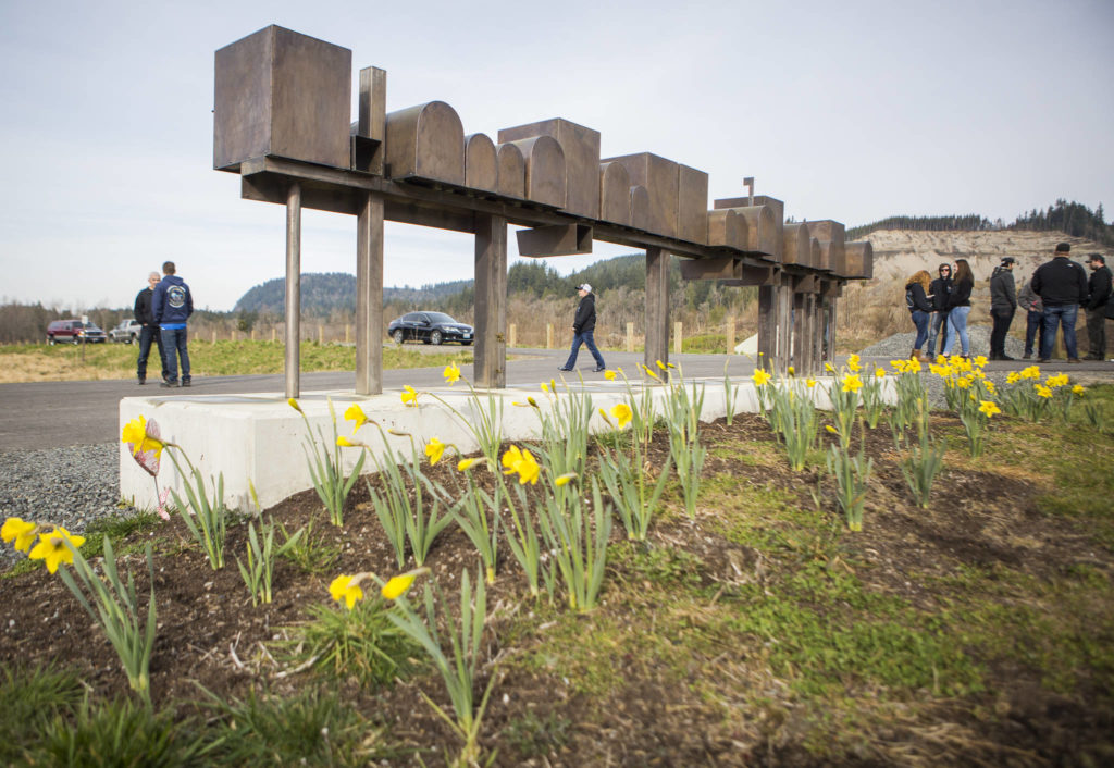 People begin to gather at the Oso slide site on Sunday near Oso. (Olivia Vanni / The Herald)
