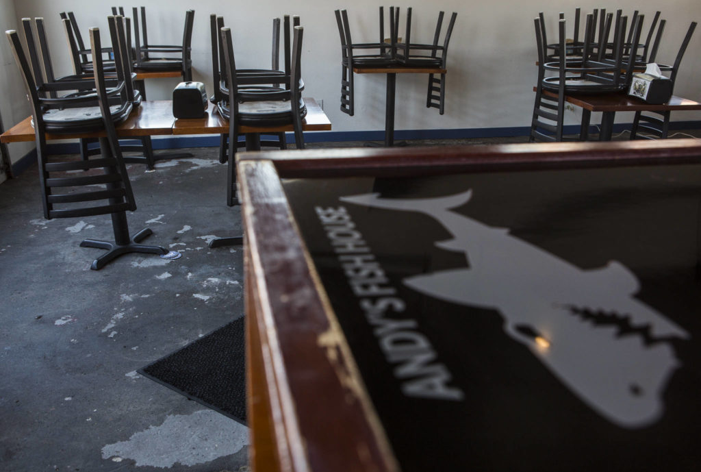 Chairs are stacked on tables in the dining area of Andy’s Fish House on Thursday in Snohomish. (Olivia Vanni / The Herald)
