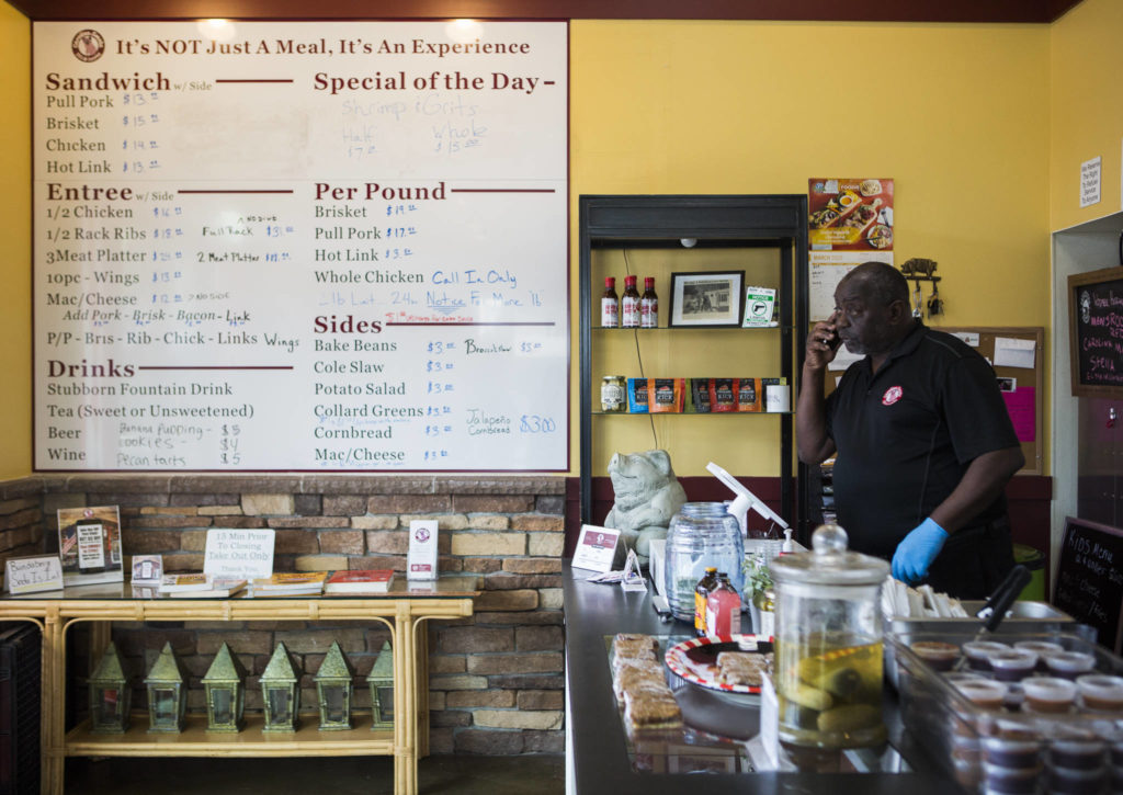 Carolina Smoke owner David Hayward takes an order over the phone Sunday. (Olivia Vanni / The Herald)
