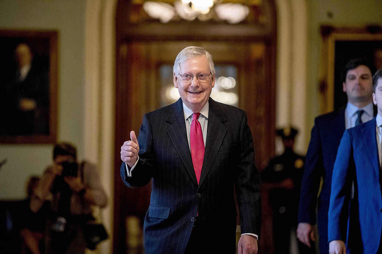 Senate Majority Leader Mitch McConnell gives a thumbs up as he leaves the Senate chamber on Capitol Hill in Washington on Wednesday, where a deal has been reached on a coronavirus bill. The $2 trillion stimulus bill is expected to be voted on in the Senate Wednesday. (AP Photo/Andrew Harnik)