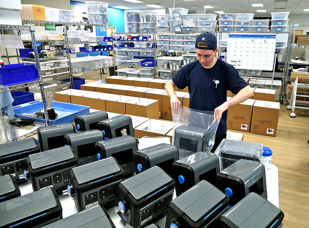 Kurt Miller prepares machines for shipment at Ventec in Bothell on March 18. (Greg Gilbert/The Seattle Times/TNS, file)