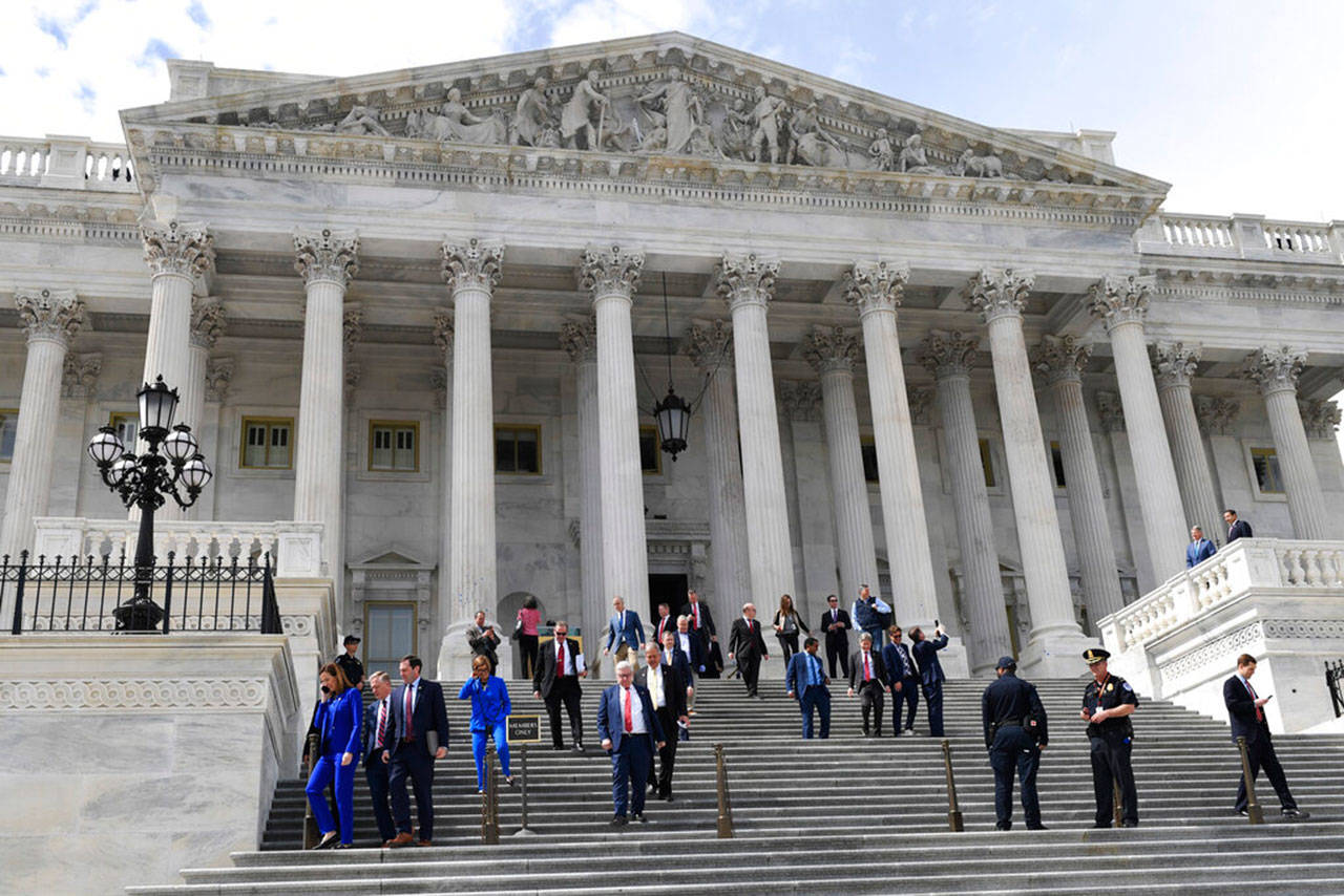 Members of the House of Representatives walk down the steps of Capitol Hill in Washington, Friday, after passing a coronavirus rescue package. Acting with exceptional resolve in an extraordinary time, the House rushed President Trump a $2.2 trillion rescue package Friday, tossing a life preserver to a U.S. economy and health care system left flailing by the coronavirus pandemic. (Susan Walsh / Associated Press)