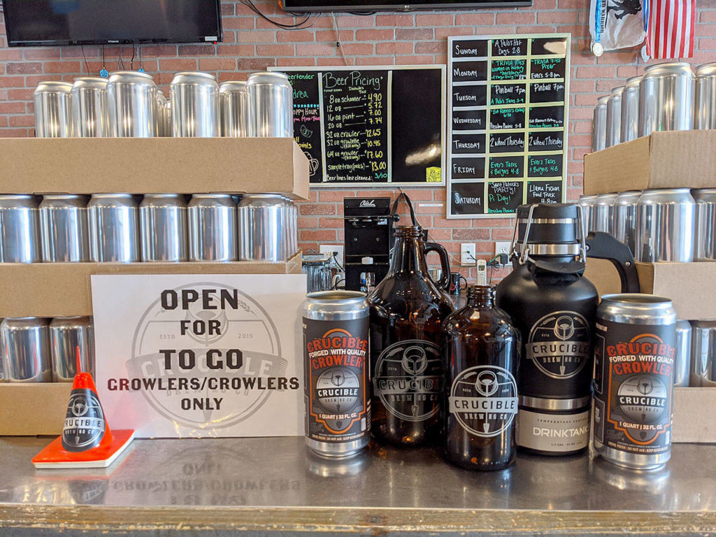 Empty cans and growlers from Everett’s Crucible Brewing wait to be filled and delivered to thirsty beer fans in and around Everett. (Crucible Brewing Co.)
