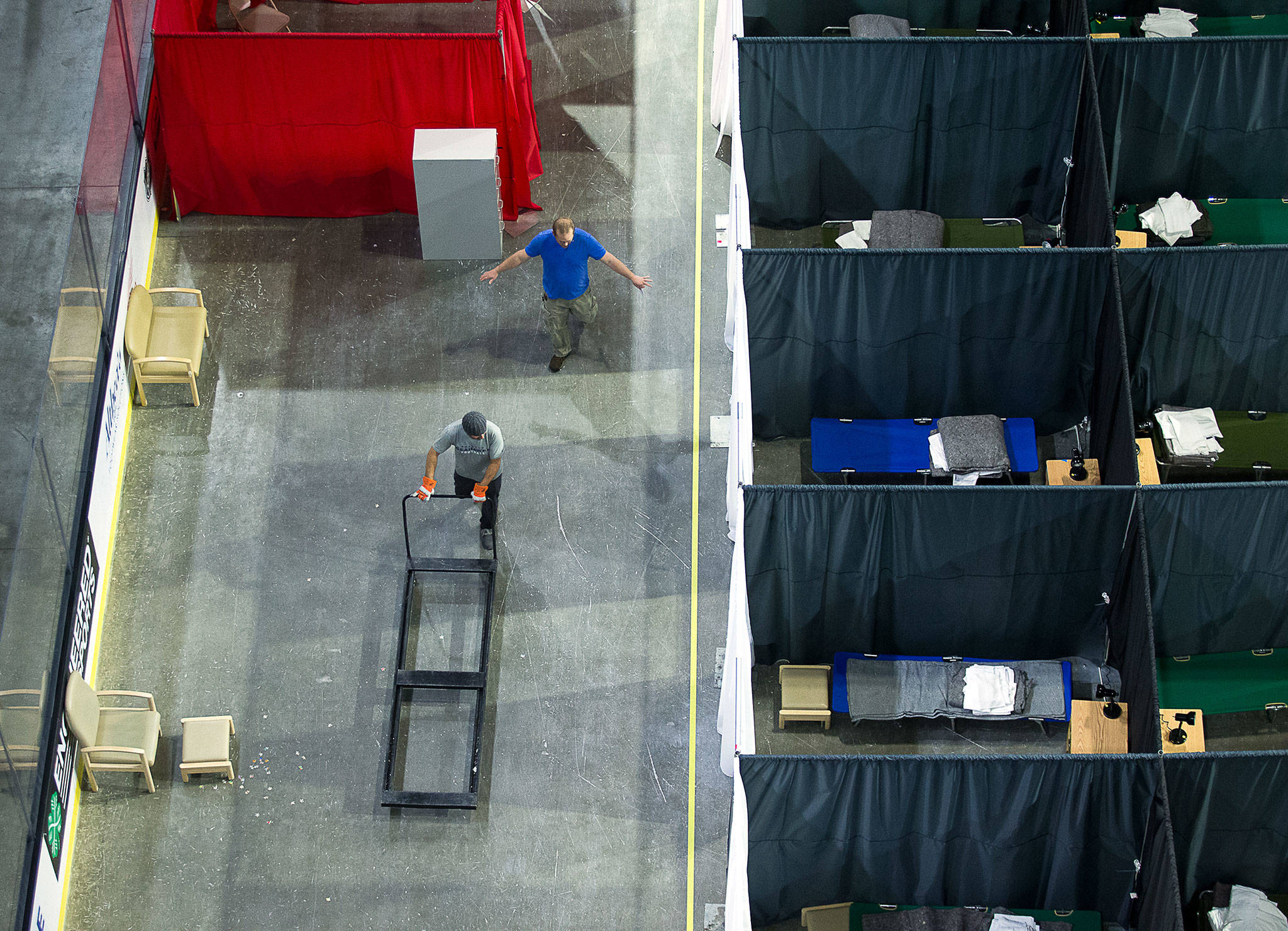 Snohomish County workers get the COVID-19 isolation and quarantine site ready at the Angel of the Winds Arena on Tuesday. (Andy Bronson / The Herald)