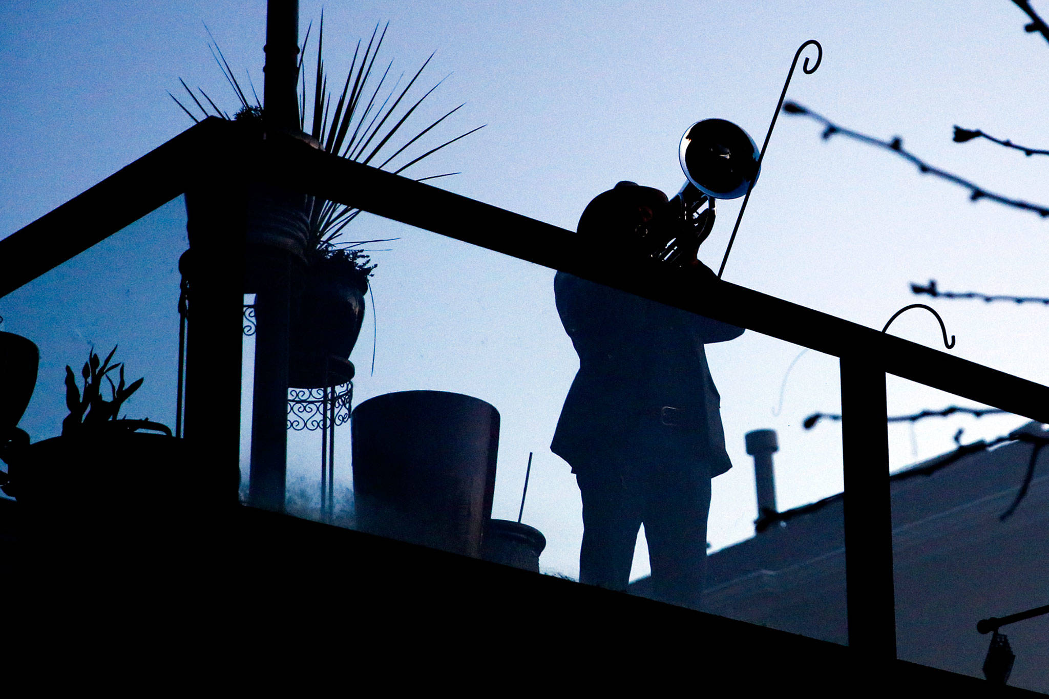 Kevin McKay plays Taps from his Everett home Wednesday — as he does every night — providing an apparently welcome sound to his neighbors in the Seahurst area. (Kevin Clark / The Herald)