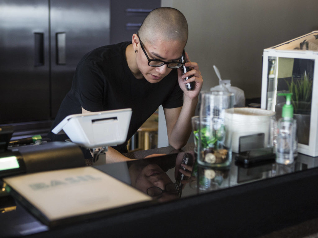 Anthony Luong takes a pick-up order over the phone at Basil Authentic Vietnamese Cuisine on April 5 in Everett. (Olivia Vanni / The Herald)
