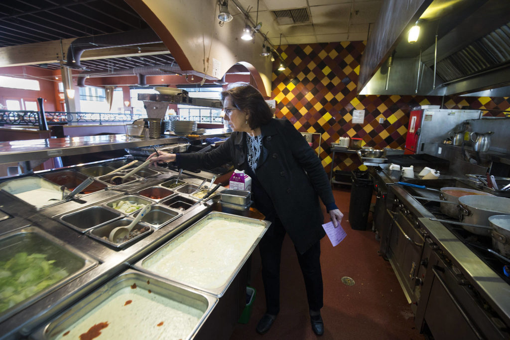 After looking around the main dinging room, Diane Symms, owner and CEO of Lombardi’s Italian Restaurants, inspects the kitchen at the Everett location on Feb. 21. (Andy Bronson / The Herald)
