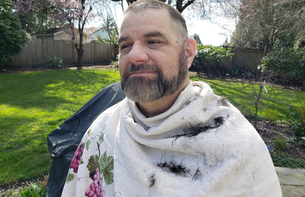 Rich Dennis after a home haircut by his wife, Ardelle, in their Everett yard. She watched a YouTube tutorial and used his beard trimmers. (Photo by Ardelle Dennis)

