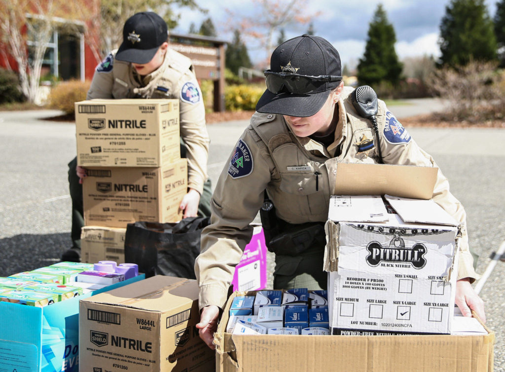 Snohomish County Park Rangers, Alyssa Gorman (left) and Chelsea Kapica gather newly donated personal protection equipment Wednesday at the Willis Tucker Park administration building in Snohomish. (Kevin Clark / The Herald)
