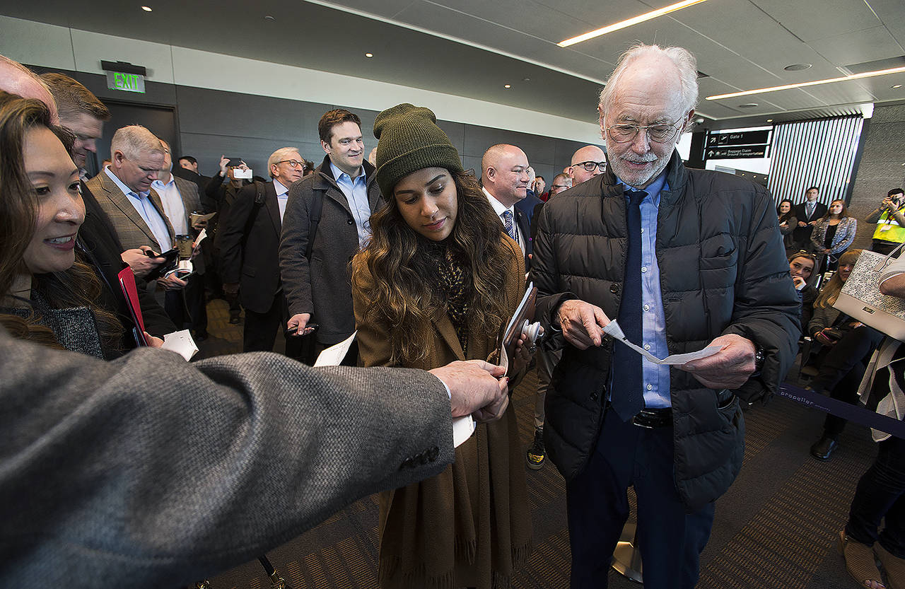 Joe Clark (right) and Samantha DeLeon (left) get their seating arrangements sorted out before boarding the first passenger flight out of the Paine Field Terminal on March 4, 2019 in Everett. (Andy Bronson / Herald file)