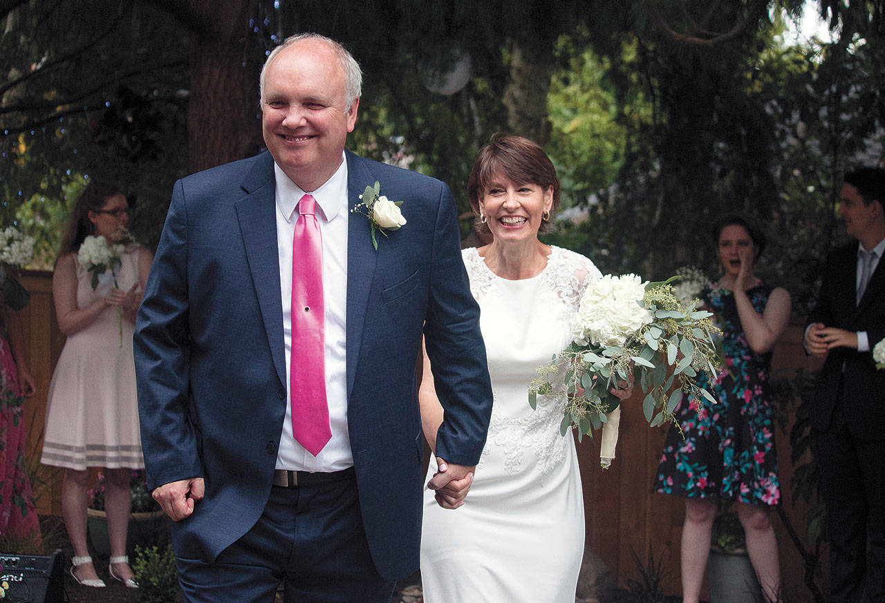 Martin Floe and Susie Allison were married in the back yard of their Lynnwood home. They dispensed with the traditional wedding formalities and had a party — both before and after saying their vows. (Jesse Dodge)