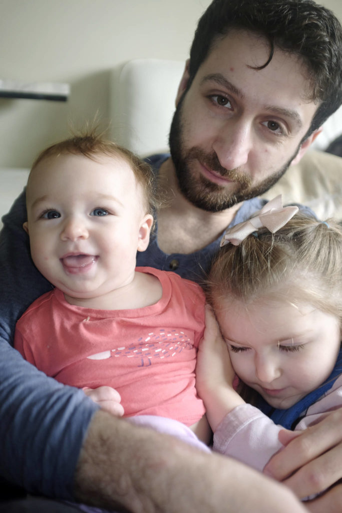 Nech Zebari, a hospital nurse, with daughters Aya, 10 months, and Mira, 3. (Photo by Megan Brown)
