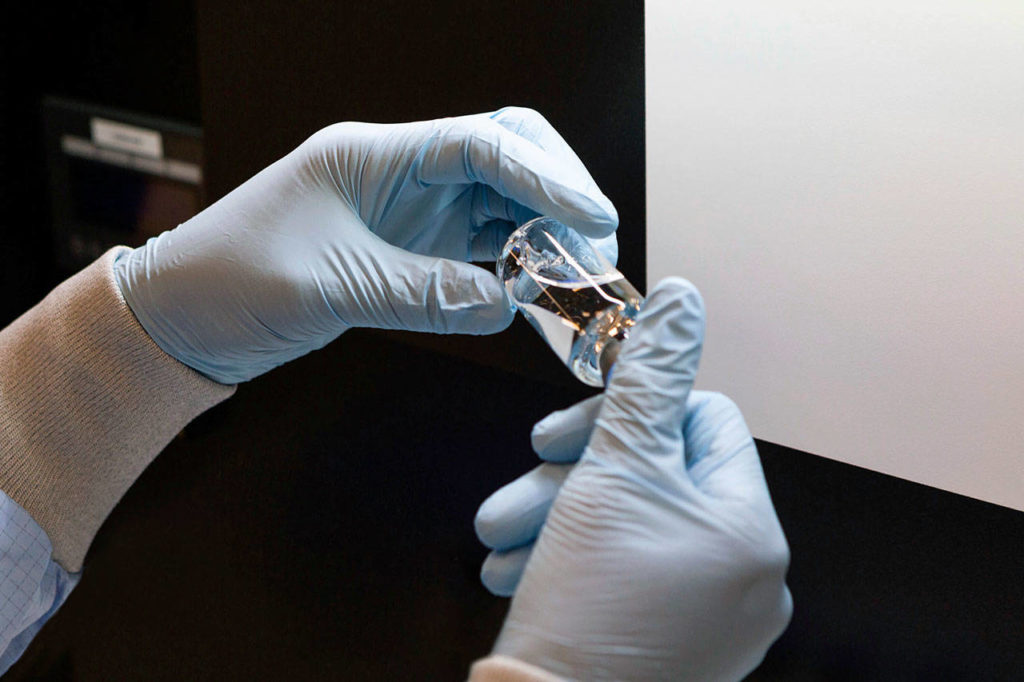 A vial of the investigational drug remdesivir is visually inspected at a Gilead manufacturing site in the United States. (Gilead Sciences via AP)
