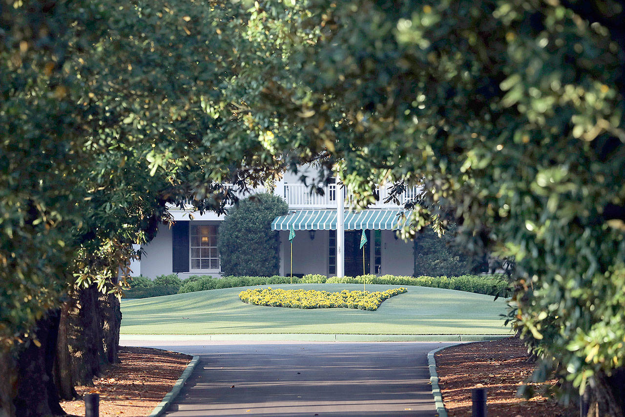 Augusta National Golf Club, seen down Magnolia Lane, is well manicured on what would have been the first practice round for the Masters golf tournament, on Monday in Augusta, Georgia. The 2020 Masters, postponed because of the coronavirus pandemic, is slated to take place Nov. 12-15. (Atlanta Journal-Constitution via AP)