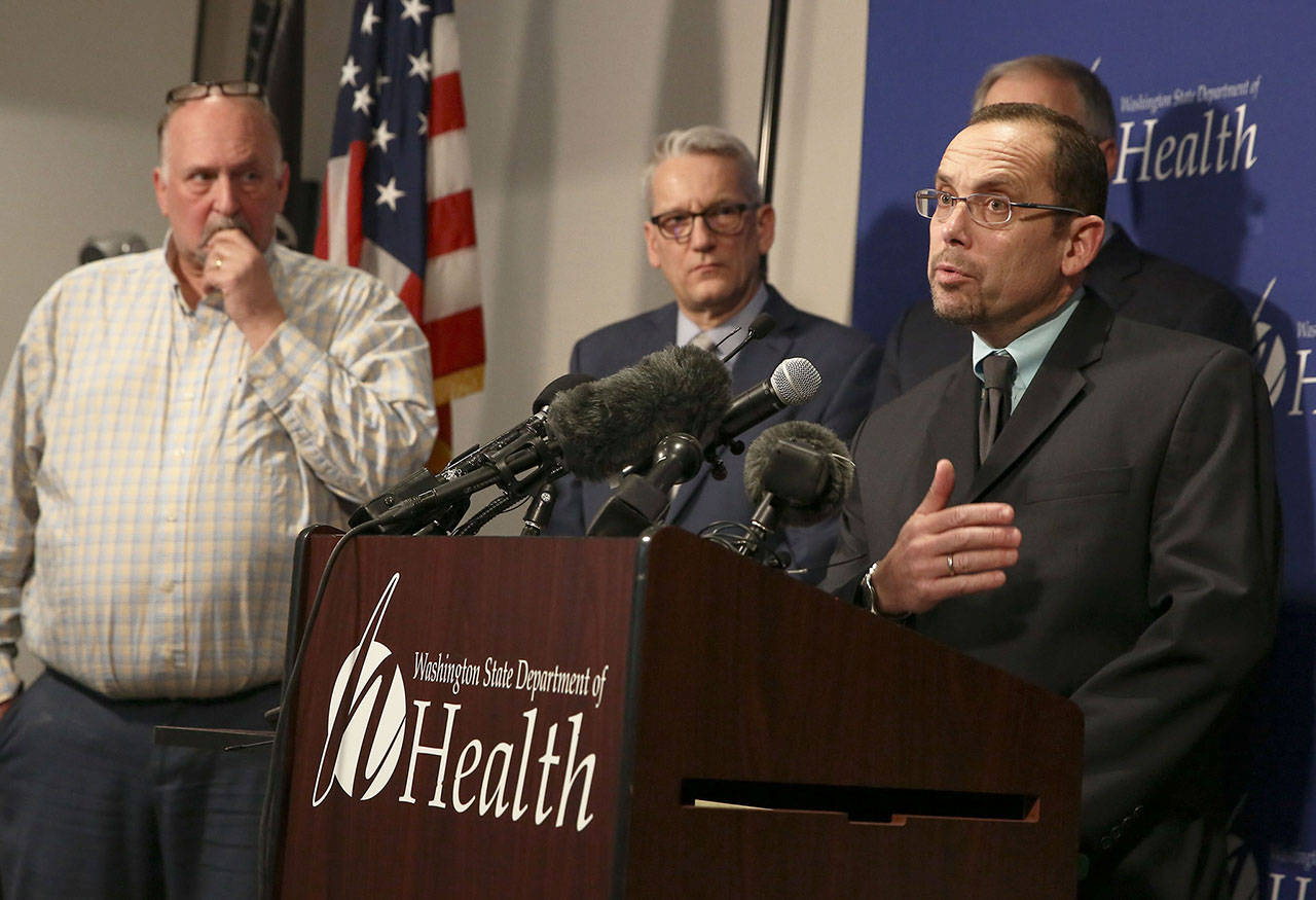 Dr. Chris Spitters (right), health officer for the Snohomish Health District, fields questions during a press conference in Shoreline on Jan. 21. (Kevin Clark / Herald file)