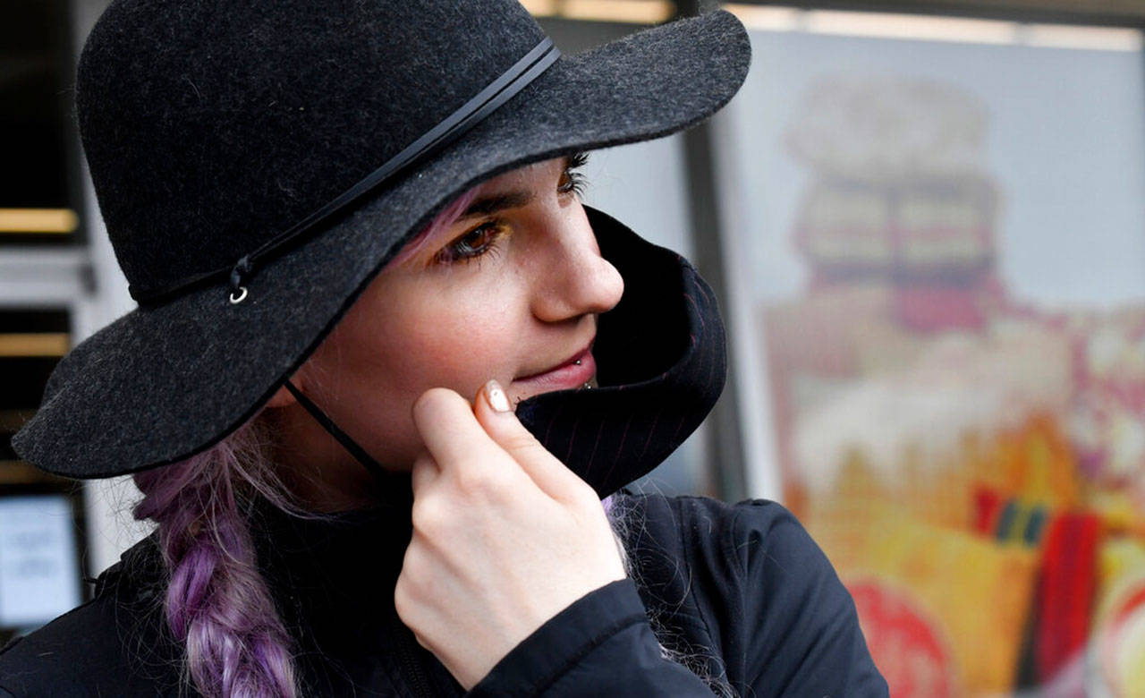 Allison Tripp, 28, pauses as she carries supplies out of Jo-Ann Fabrics and Crafts on March 29, in Spokane. Tripp, who has been sewing for most of her life, said she had made almost 25 masks and can make almost five an hour. Tripp added that she began making the masks after her aunt died alone in a quarantine unit in a California hospital with COVID-19 symptoms although she later tested negative for the disease. Jo-Ann Fabrics and Crafts is offering free mask-making kits to patrons. (The Spokesman-Review / Tyler Tjomsland)