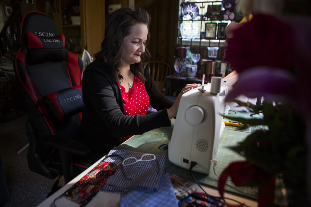 Nikki Speaks works on a handful of new masks at her home on April 10 in Woodinville. (Olivia Vanni / The Herald)
