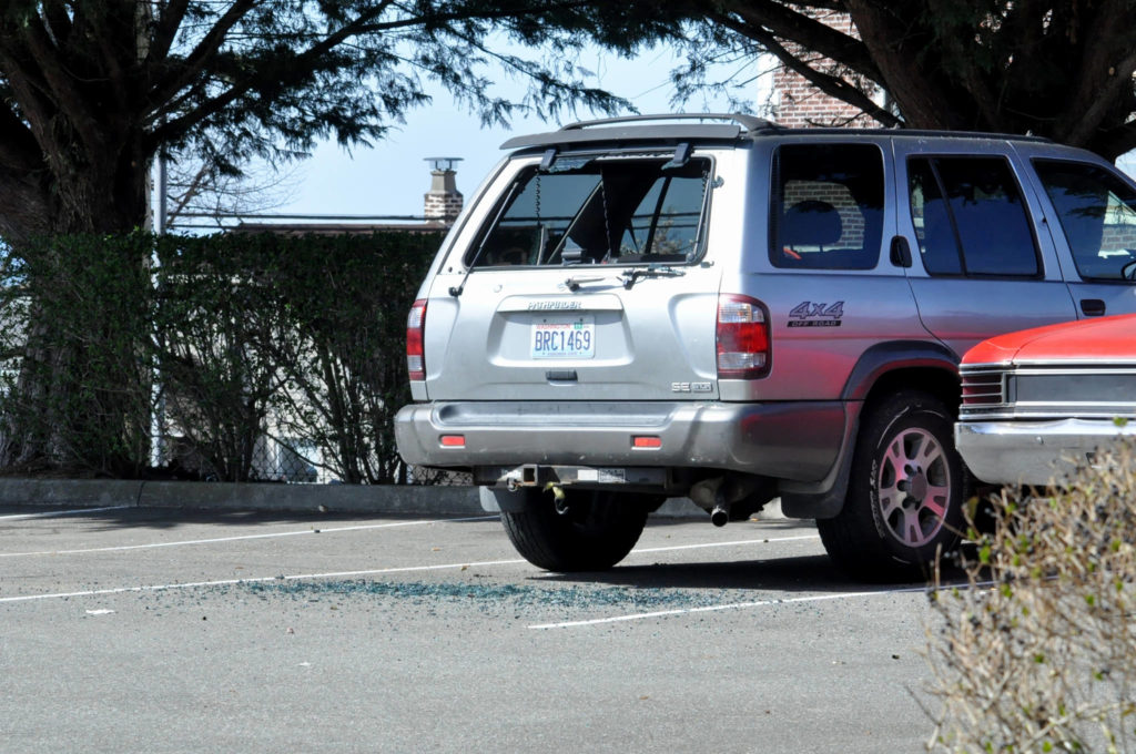 A vehicle with shattered glass sits in the parking lot where a fatal shooting occurred Thursday afternoon in northwest Everett. A different vehicle, which had been struck by bullets, was later found at Providence Regional Medical Center. (Sue Misao / The Herald)
