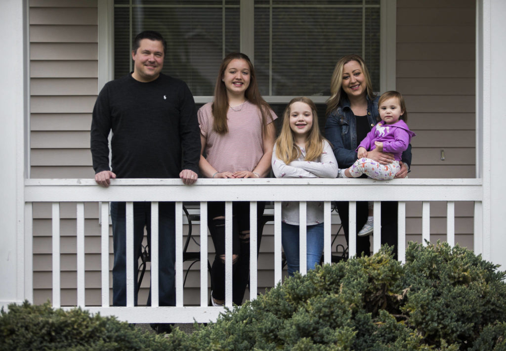 From left: Kris Baier, Kendall Wright, 14, Julia Wright, 9, Kristan Baier and Lily Baier, 1, outside their home in Everett. (Olivia Vanni / The Herald)
