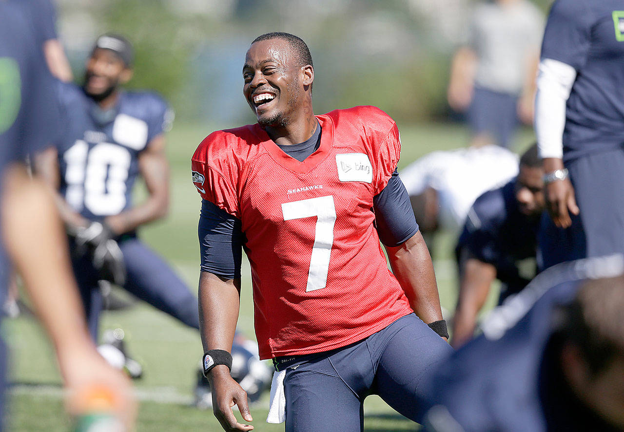 FILE - In this July 27, 2014, file photo, Seattle Seahawks quarterback Tarvaris Jackson smiles while stretching at an NFL football camp practice in Renton. The former NFL quarterback died in a one-car crash outside Montgomery, Ala., authorities said Monday. (Associated Press)