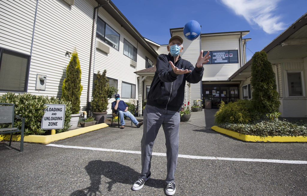 Michael O’Donnell, 81, catches a football Tuesday as he throws around with staff and residents of the Sunrise View Retirement and Rehabilitation Center in Everett. (Andy Bronson / The Herald)
