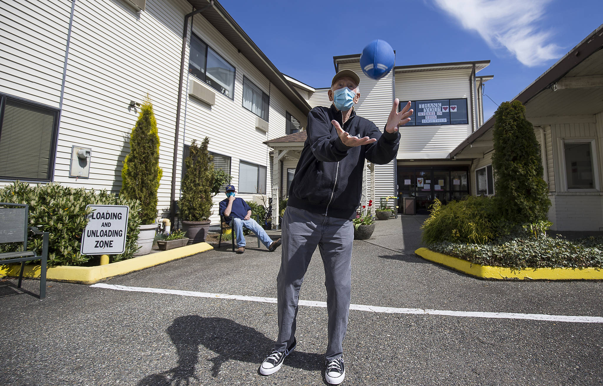 Michael O’Donnell, 81, catches a football Tuesday as he throws around with staff and residents of the Sunrise View Retirement and Rehabilitation Center in Everett. (Andy Bronson / The Herald)