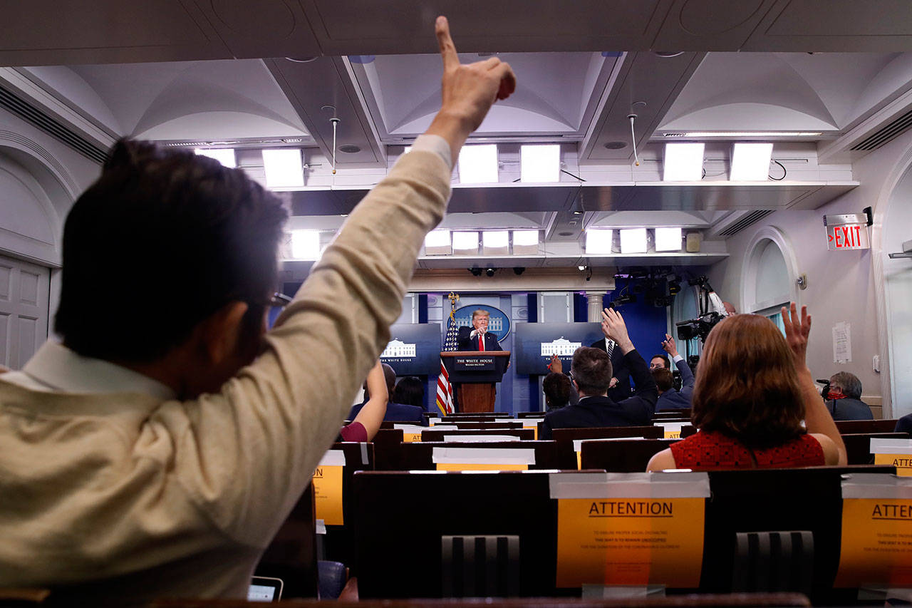 Reporters raise their hands to ask a question of President Trump during a briefing about the coronavirus in the James Brady Press Briefing Room of the White House, April 8, in Washington, D.C. (Alex Brandon / Associated Press)                                Alex Brandon / Associated Press                                Reporters raise their hands to ask a question of President Trump during a briefing about the coronavirus in the James Brady Press Briefing Room of the White House, April 8, in Washington, D.C.