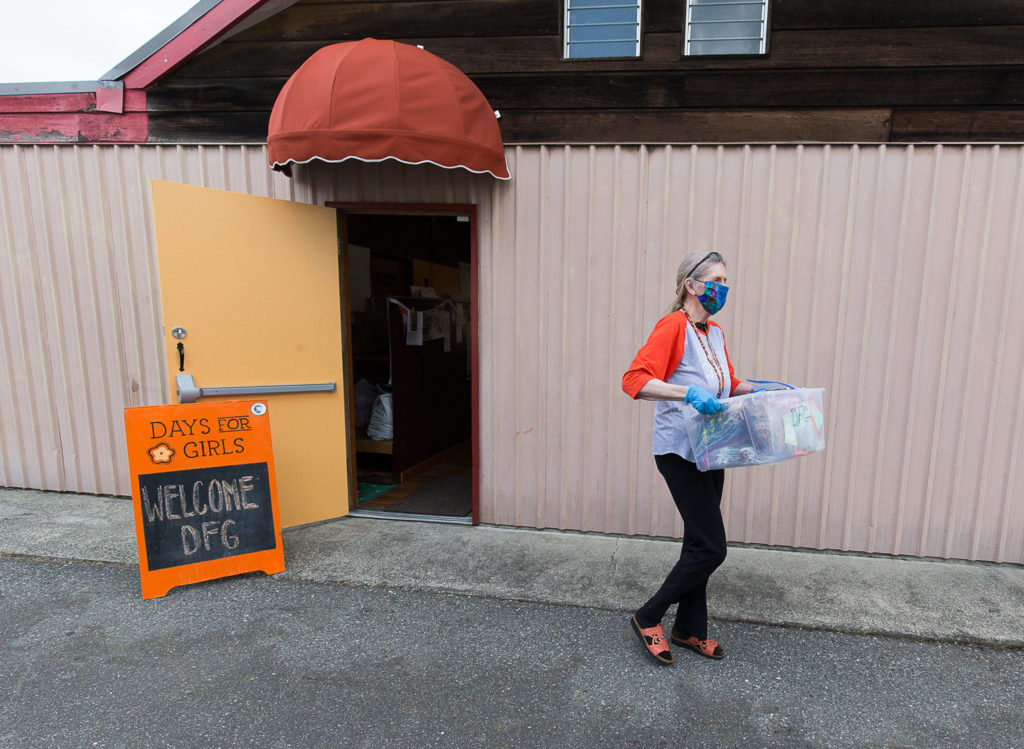 Days for Girls’ Miriam Lancaster heads out from Viking Hall in Stanwood on Saturday with 300 masks for a Seattle nursing home. Recently the group sewed, collected and distributed 700 masks for the USS Ralph Johnson, based in Everett. (Andy Bronson / The Herald)
