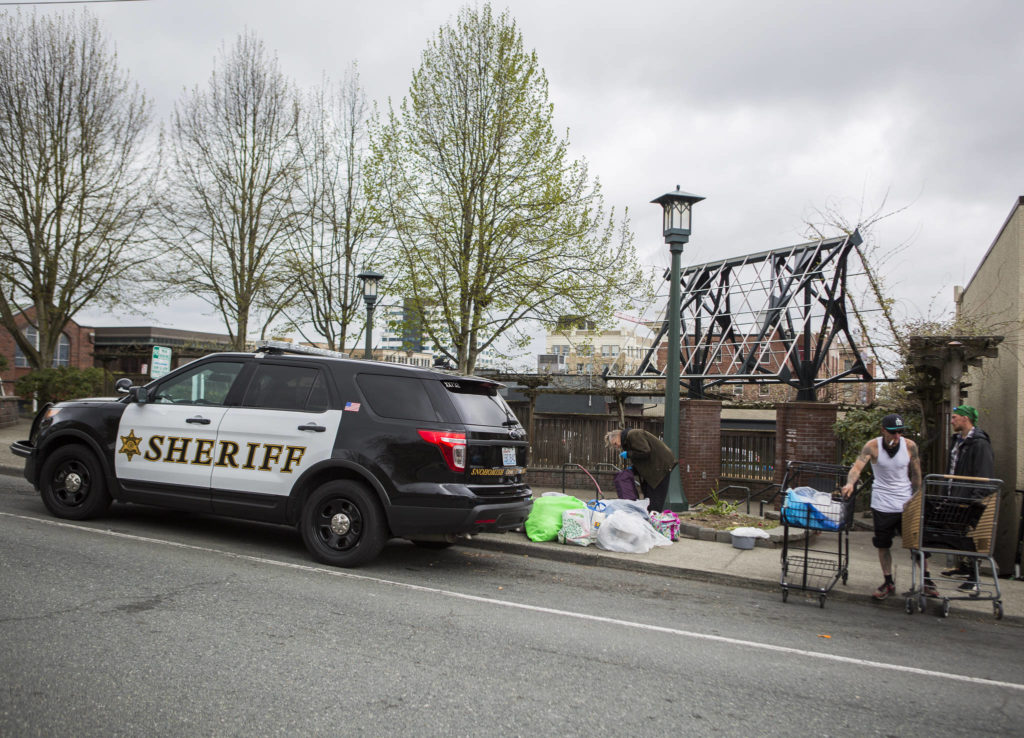 The Snohomish County sheriff deputies clear out the remaining people from a homeless camp at Matthew Parsons Park on Tuesday in Everett. (Olivia Vanni / The Herald)
