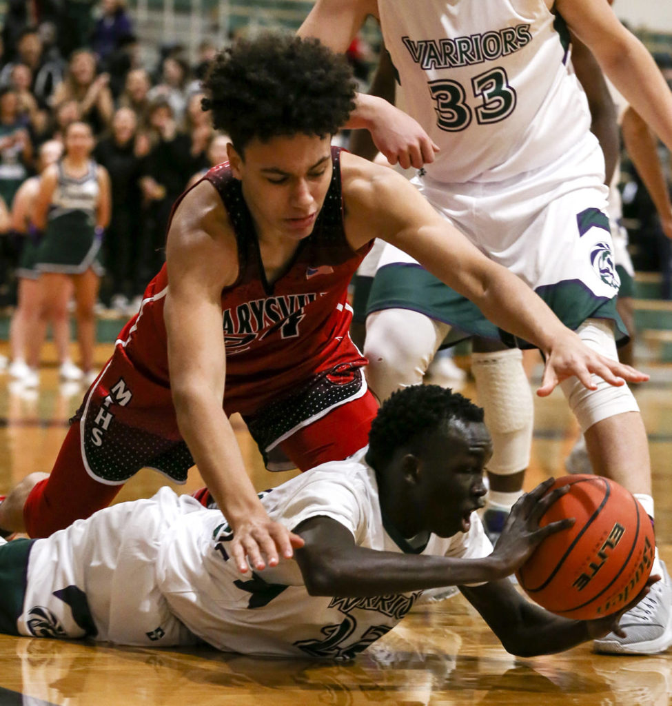 Edmonds-Woodway’s Mutdung Bol (bottom) struggles for a loose ball with Marysville Pilchuck’s Ethan Jackson reaching in during a game on Dec. 14, 2018, at Edmonds-Woodway High School. (Kevin Clark / Herald file)
