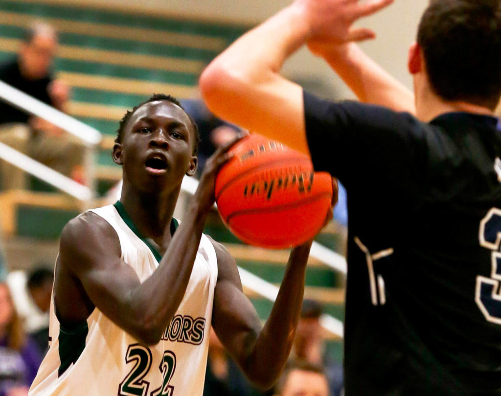 Edmonds-Woodway’s Mutdung Bol (left) attempts a shot during a game against Arlington on Jan. 9, 2019, at Edmonds-Woodway High School. (Kevin Clark / Herald file)
