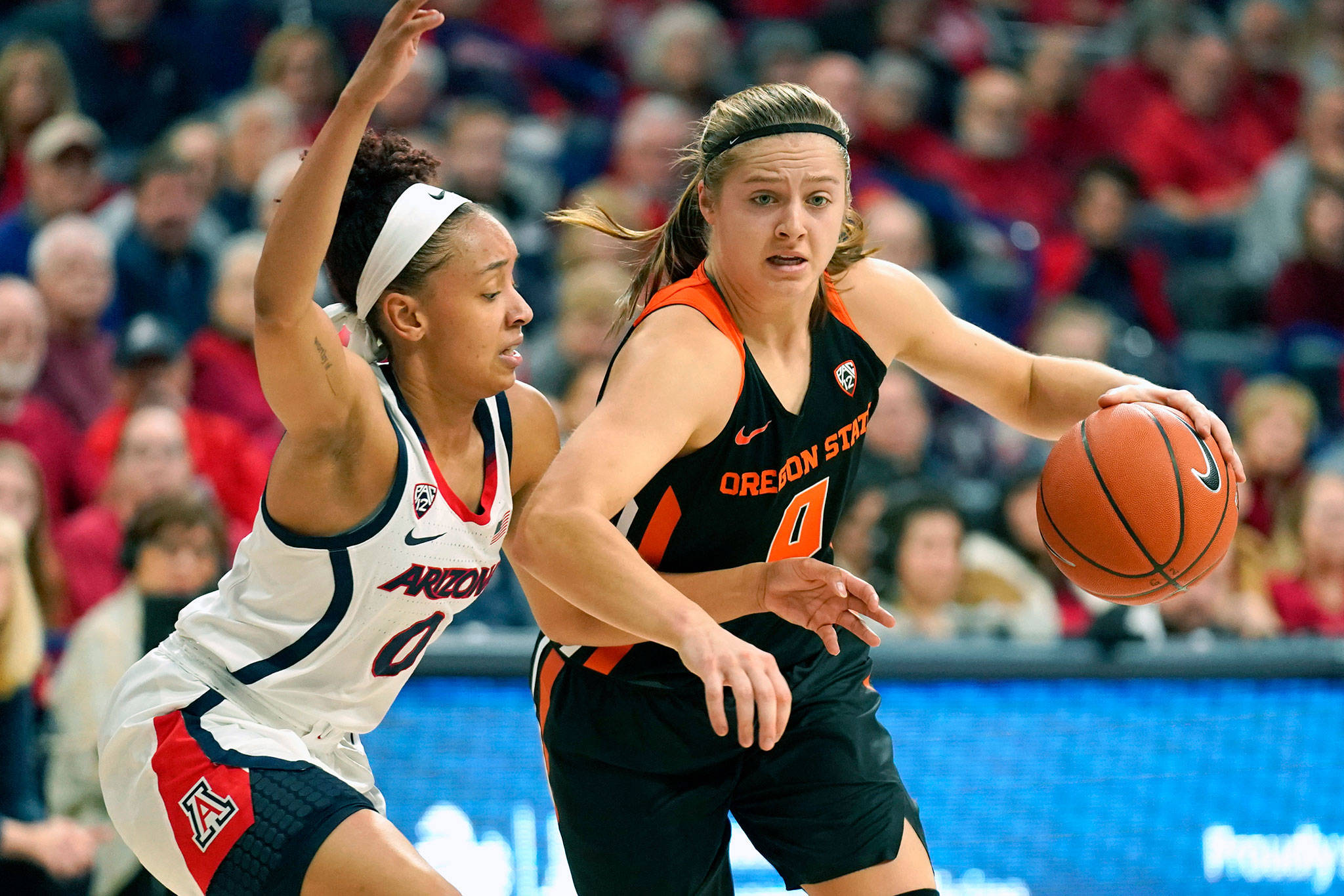 Oregon State guard Mikayla Pivec (right), a Lynnwood High School alum, drives to the basket against Arizona guard Amari Carter during the first half of a game Jan. 10, 2020, in Tucson, Ariz. (AP Photo/Rick Scuteri)