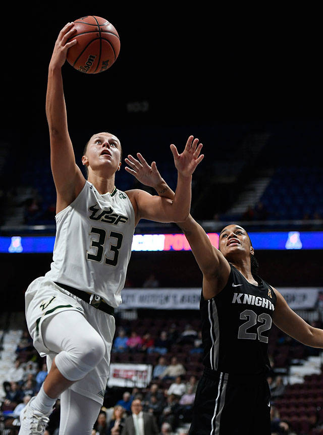 Kitija Laksa (left) shoots as Central Florida’s Aliyah Gregory defends during a game between South Florida and Central Florida in 2018 at Mohegan Sun Arena in Uncasville, Conn. Laksa was selected by the Seattle Storm with the 11th pick in the first round of Friday’s WNBA draft. (Jessica Hill / Associated Press)