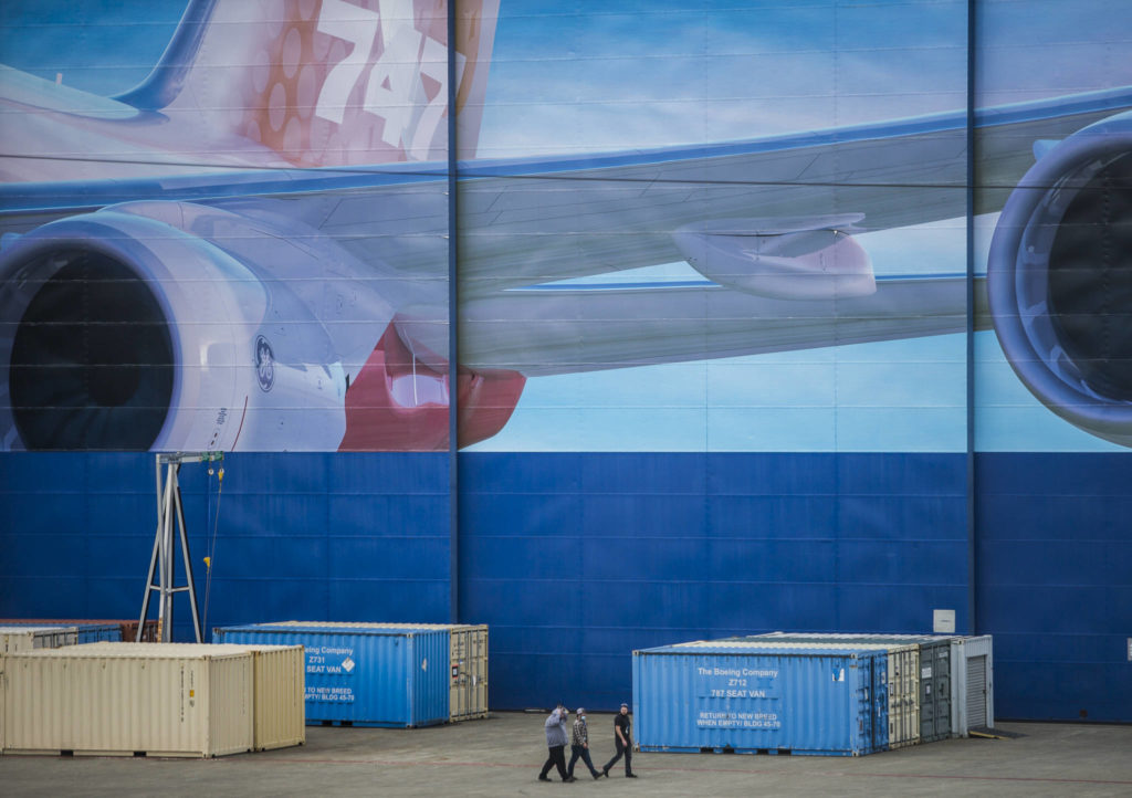 Boeing workers walk outside Boeing’s Everett assembly plant on Tuesday. (Olivia Vanni / The Herald) 
