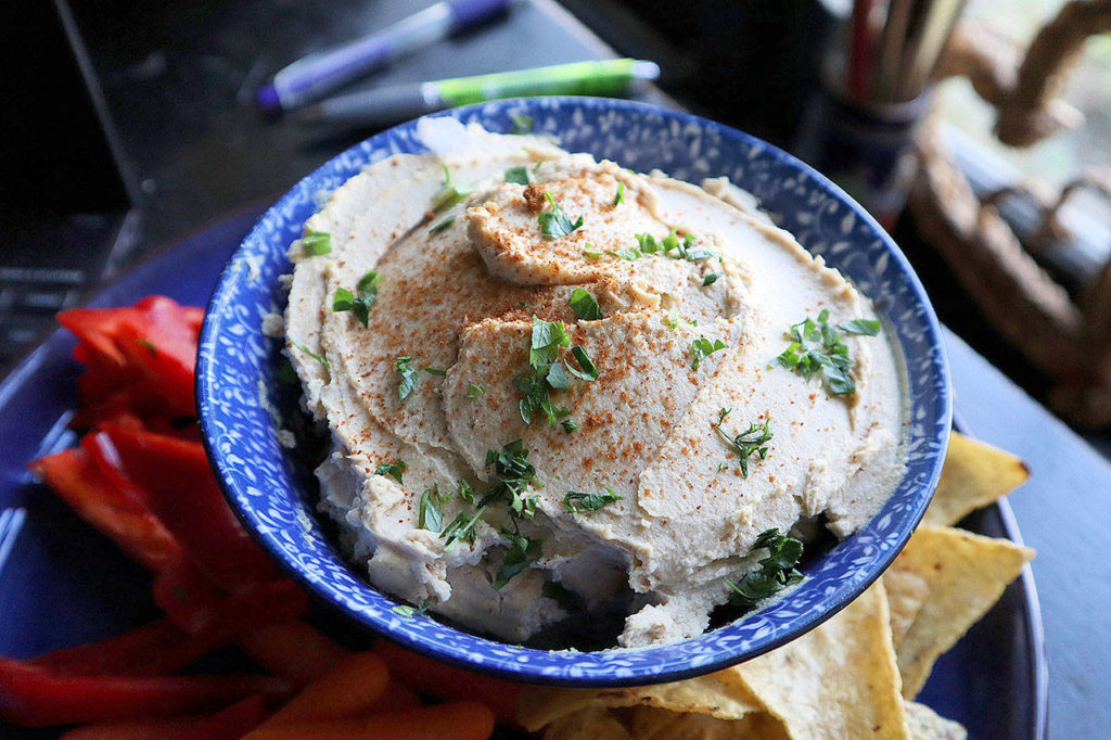 Hummus, a creamy Middle Eastern dip made with chickpeas and tahini paste, is perfect for mindless dipping. (Gretchen McKay/Pittsburgh Post-Gazette)
