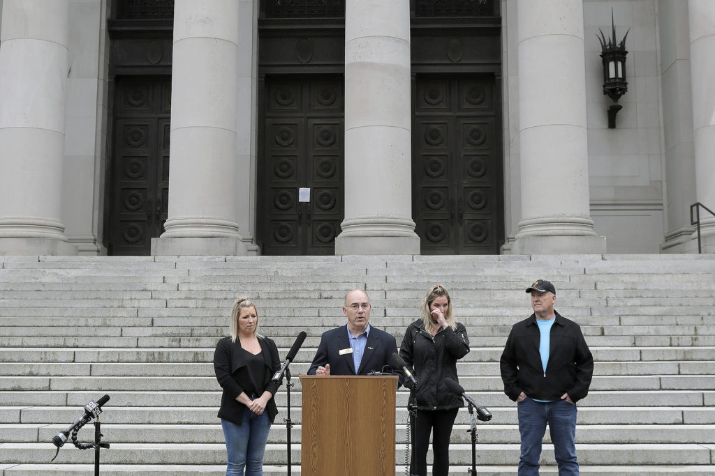 Washington state Sen. Keith Wagoner, R-Sedro-Woolley (second from left), stands with family members of Julie Binschus, who was murdered in 2008, outside the Temple of Justice on Thursday at the Capitol in Olympia. Wagoner, Julie’s husband Fred Binschus (right), and her daughters Tonya Fenton (left) and Trisha Woods (second from right) joined others in speaking out against the release of prison inmates due to the spread of the coronavirus as Washington state Supreme Court justices heard oral arguments inside on the issue using remote video technology. (AP Photo/Ted S. Warren)
