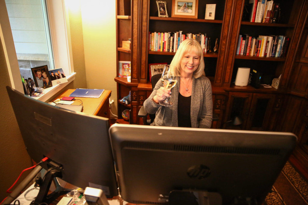 Due to the coronavirus stay home order, Jill Sundin of Bothell started a weekly Zoom happy hour to connect friends from six states for wine and cocktails. (Kevin Clark / The Herald)
