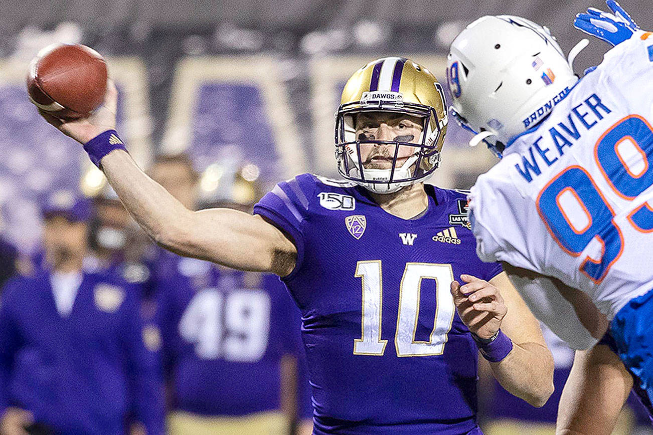 Washington quarterback Jacob Eason throw around the rush of Boise State’s Curtis Weaver for a touchdown pass in the first quarter of the Las Vegas Bowl on Dec. 21, 2019. Eason, a Lake Stevens alum, was one of 58 players — and the only UW player — invited to participate in the NFL Draft’s virtual event. (Darin Oswald/Idaho Statesman)