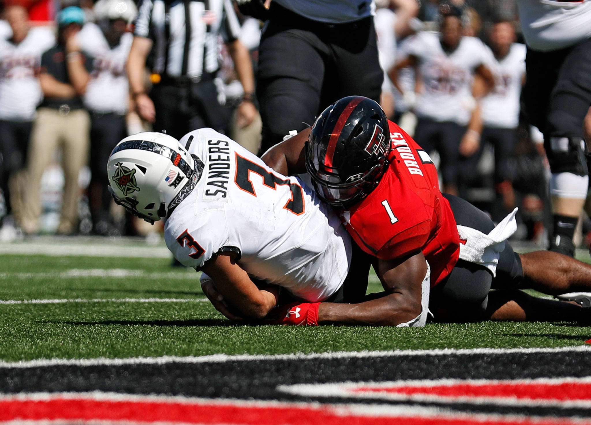 Texas Tech’s Jordyn Brooks (1) tackles Oklahoma State’s Spencer Sanders to stop a two-point conversion during the second half of a game Oct. 5, 2019, in Lubbock, Texas. (AP Photo/Brad Tollefson)