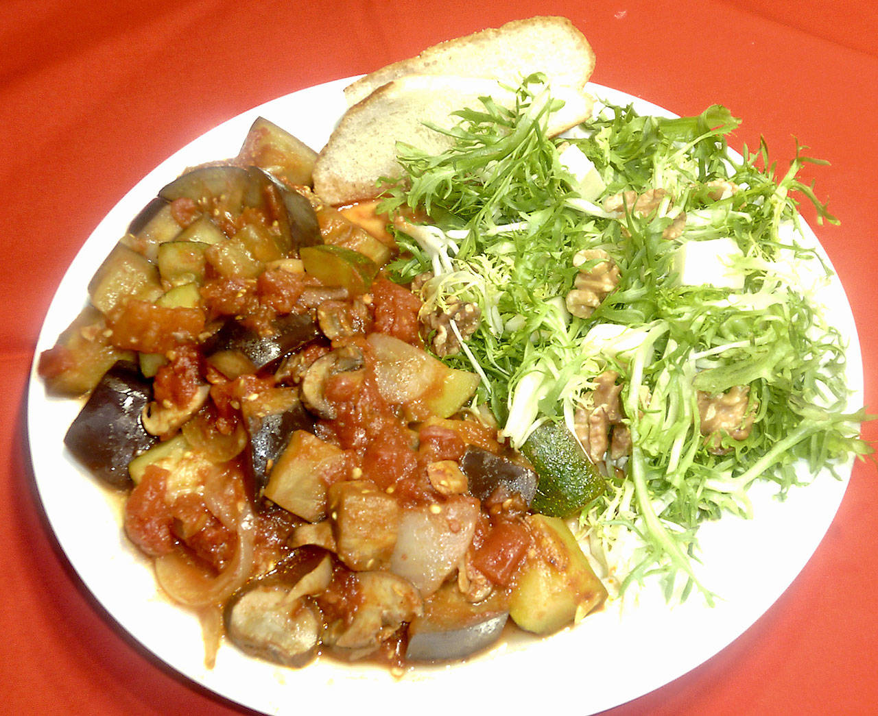 You don’t to stand at the stove for hours to make this simple ratatouille (sauteed Provencal vegetables) with French frisee salad. (Linda Gassenheimer)
