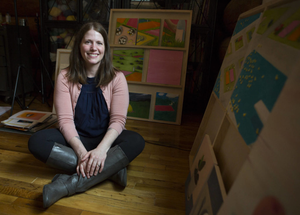 Amanda Adams, seen here in her bedroom art studio at her Monroe home, specializes in vivid oil paintings that range from surreal to representational. (Olivia Vanni / The Herald)
