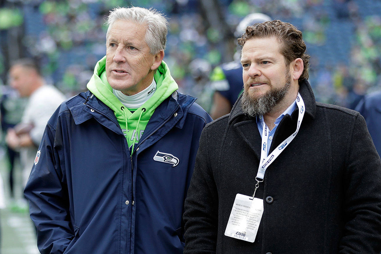 Voters gave Seattle Seahawks general manager John Schneider (right) and coach Pete Carroll middling grades for the 2020 draft. (AP Photo/Ted S. Warren, File)