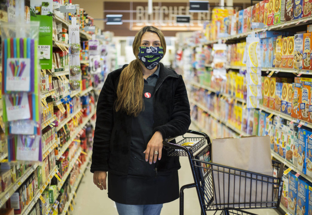 Essential worker Amber Rodriguez is a store clerk at the Silver Lake Safeway in Everett. (Olivia Vanni / The Herald)
