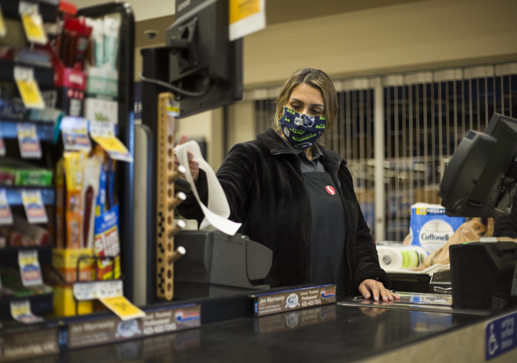 Amber Rodriguez checks out a customer at the Silver Lake Safeway in Everett. (Olivia Vanni / The Herald)
