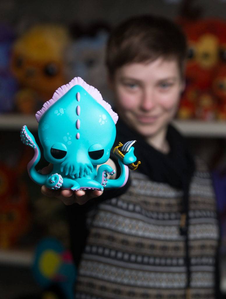 Erika Flak poses with the Myths & Legends Kraken, which she designed, at Funko headquarters on Jan. 13 in Everett. (Andy Bronson / The Herald)
