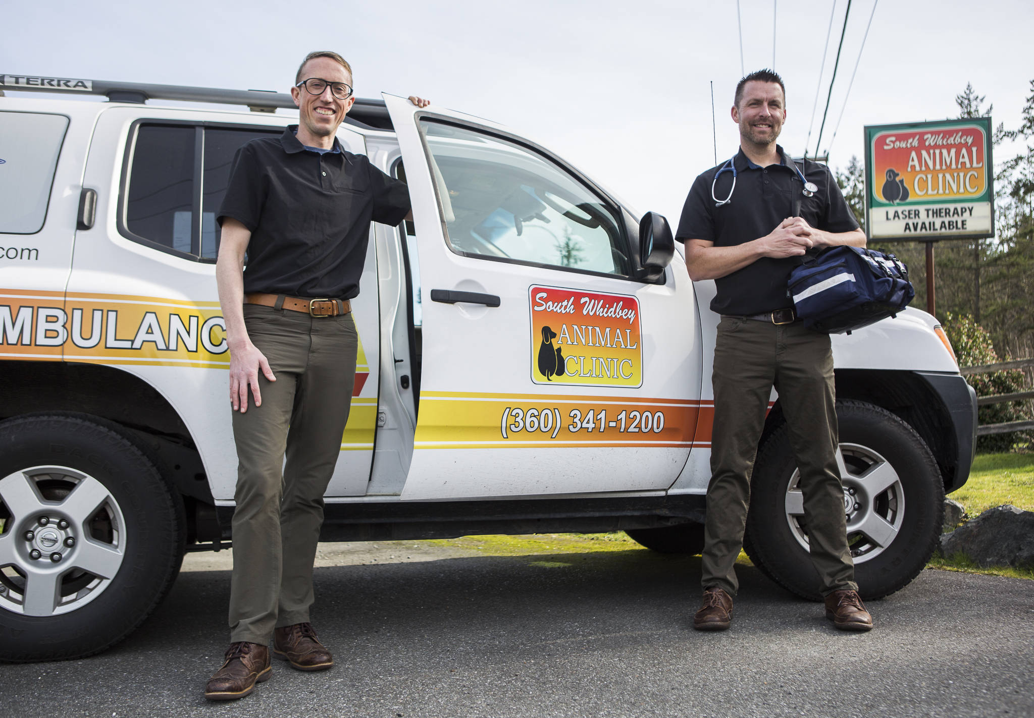 South Whidbey Animal Clinic veterinarians Dr. Rob Jung, left, and Dr. Eric Patrin with their pet ambulance in Clinton. (Olivia Vanni / The Herald)